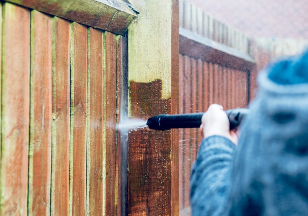 Cleaning and Renovating Wood Fence with powerful jet wash or pressure washer, spring cleaning of the garden and house